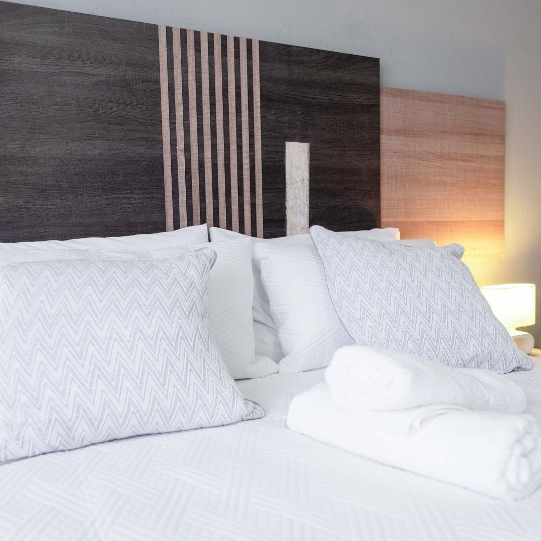 Bedroom with chevron pillows and warm linen — Viata Luxe
