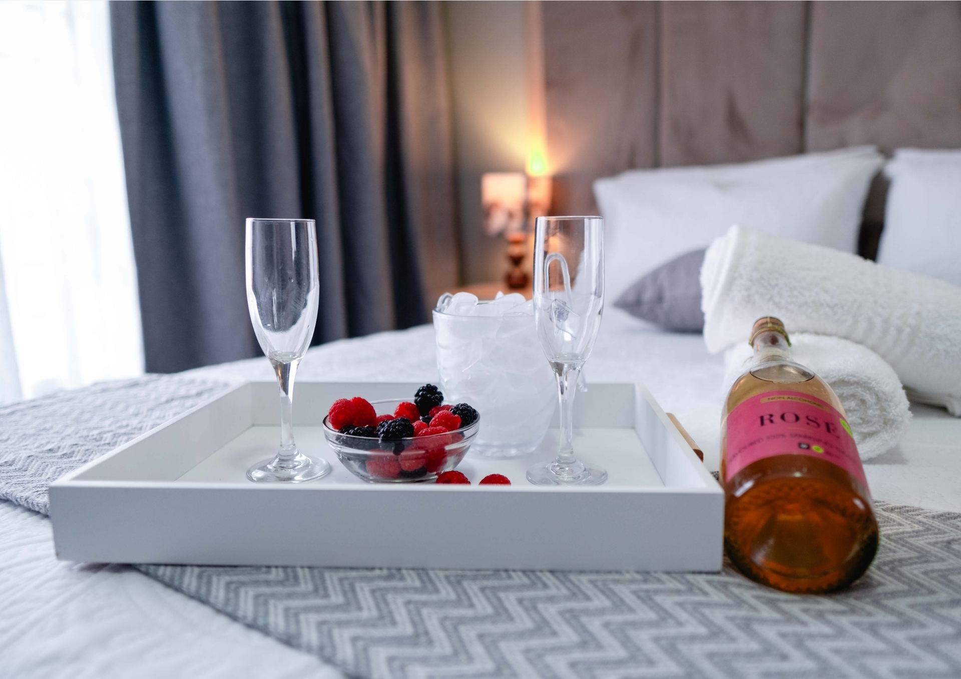 Rosé champagne and berries tray on crisp linen — Viata Luxe