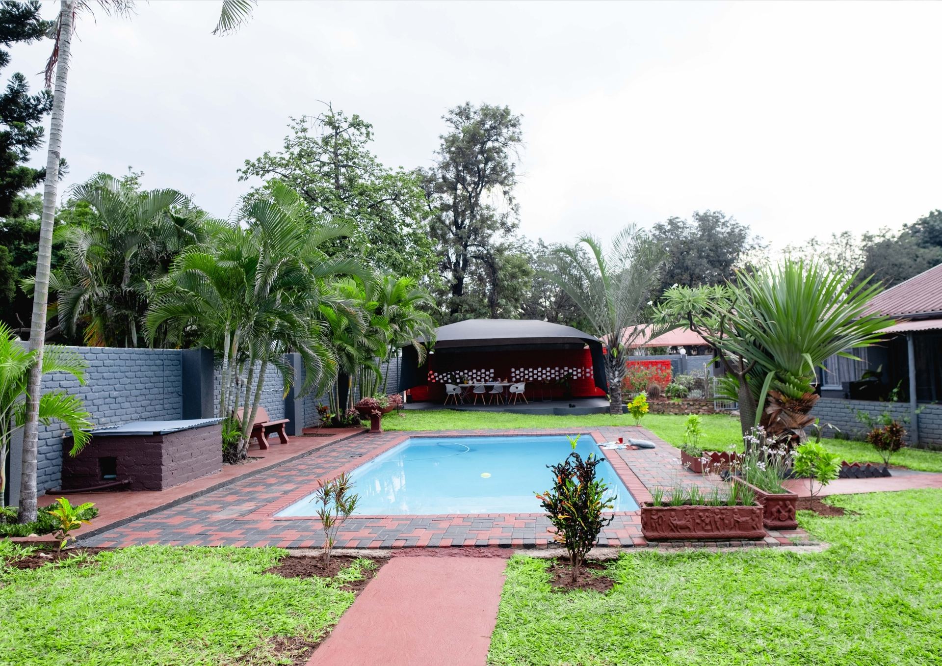 Pool nestled in lush garden at golden hour — Viata Luxe